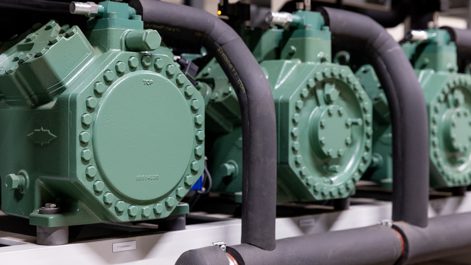 detailed view of compressor rack, close-up of reciprocating compressors